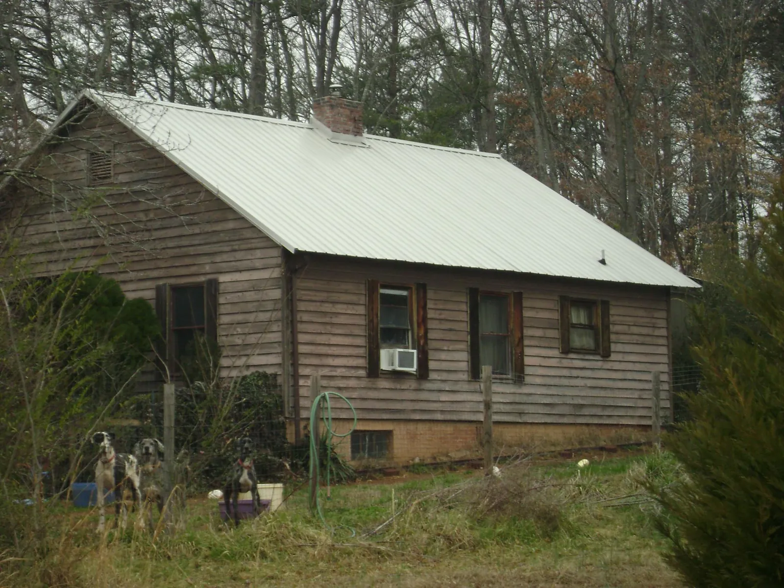 White metal roof on an old wood sided farmhouse, from a Metal Roof Installation job in Goode